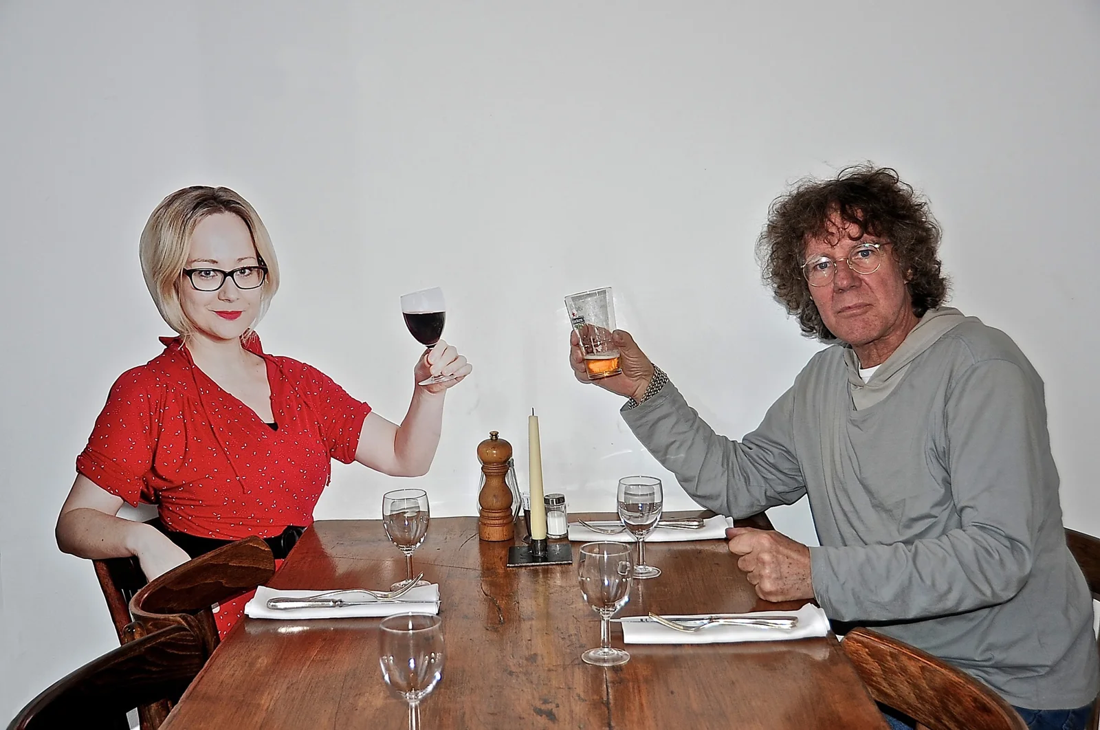 A visitor shares a table with a life-size photographic cutout at De Kring.