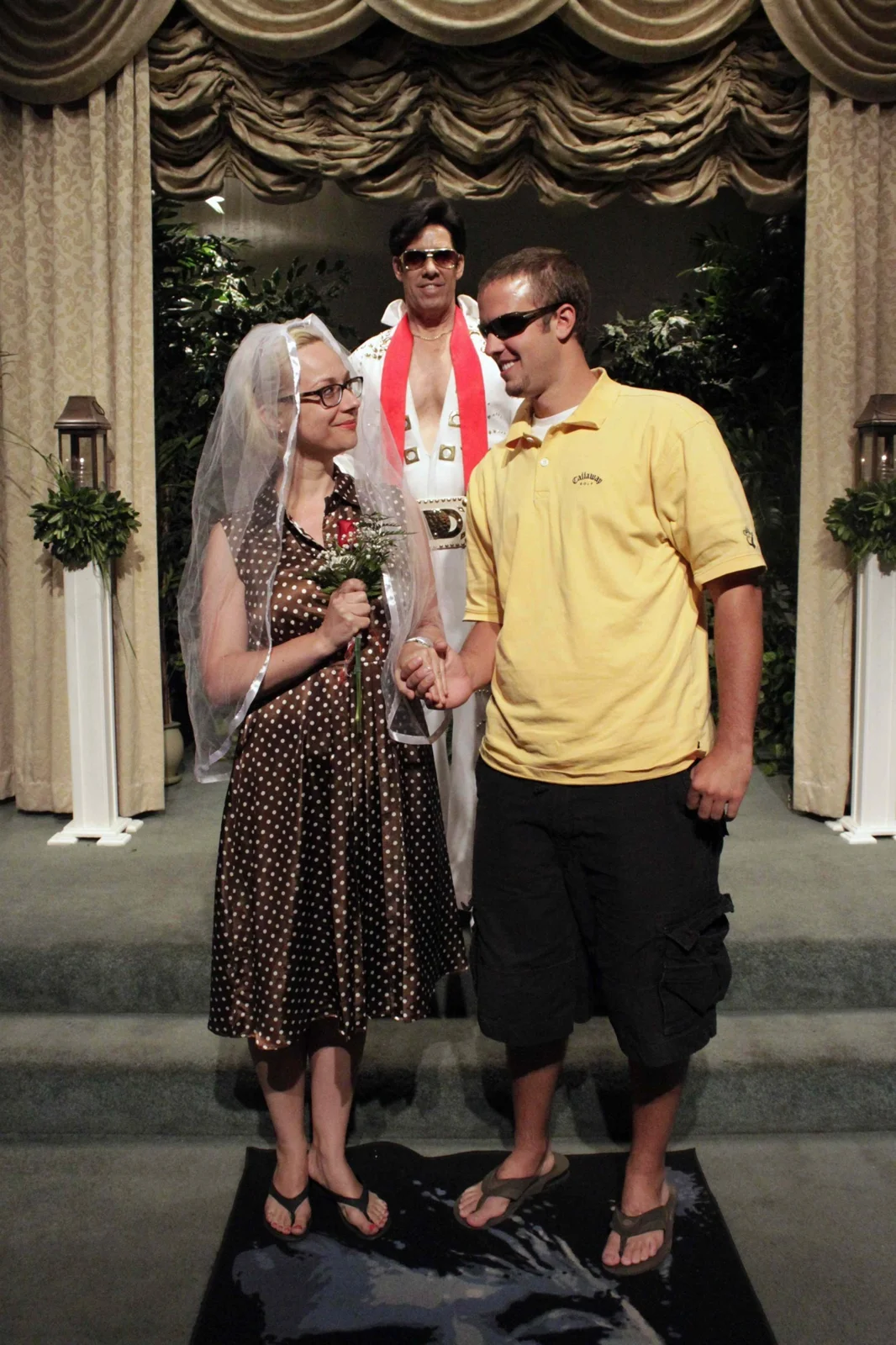 Three people pose at a wedding chapel in Las Vegas, from Constructions of Happiness.