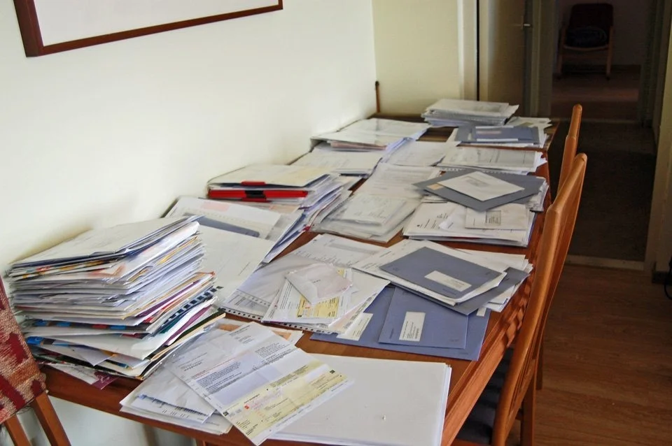 A table covered in papers and documents, from the Sporen archive selection.